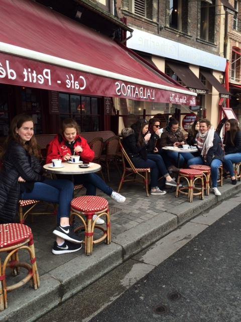 students seated at a french cafe in paris